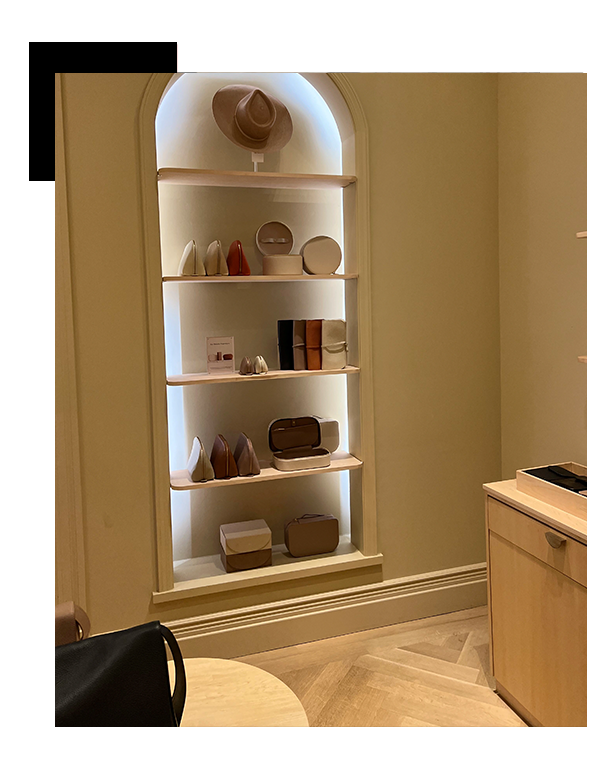 general-construction-contractor-San-Carlos-Ave-9-2 1 - JE Handyman Home Service A neatly organized accessory display in a boutique with items including handbags, shoes, and hats on white shelves within an arched alcove sheetrock.